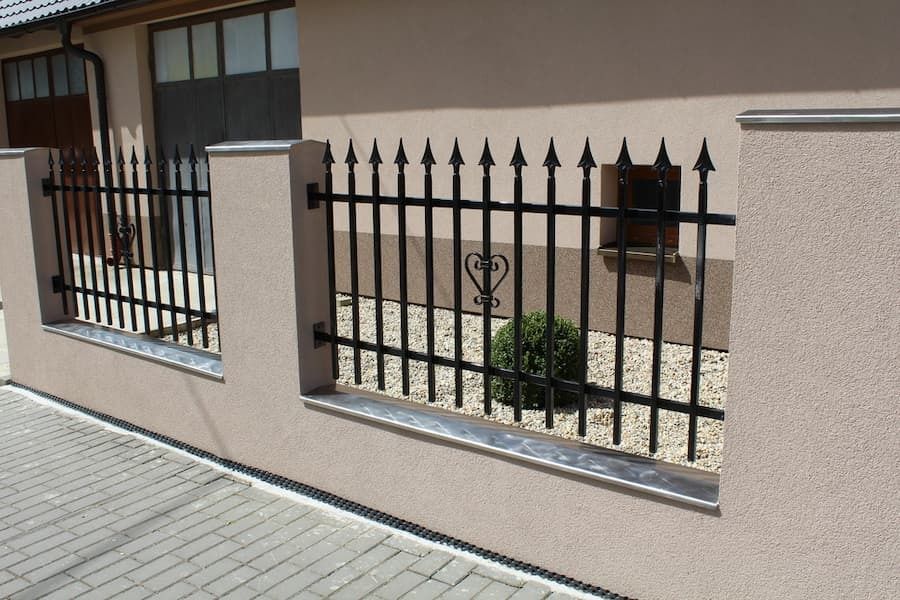 Black Metal Railings Mounted Between Stucco Pillars — A Betta Fence 'N' Yard In Port Macquarie, NSW