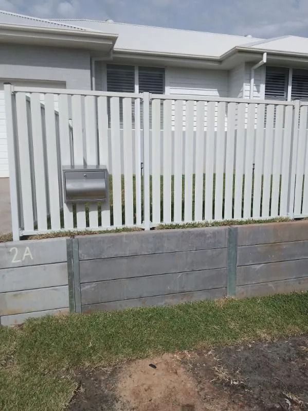 A Grey Slatted Fence With a Mounted Metal Mailbox — A Betta Fence 'N' Yard In Lake Cathie, NSW