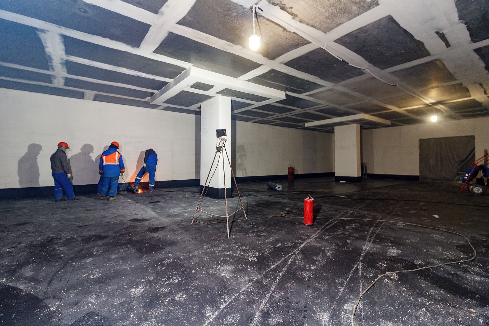 Basement waterproofing in progress done by a group of professional workers. Basement waterproofing in progress done by a group of professional workers.