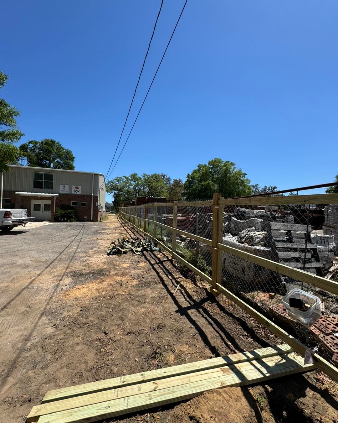 A wooden fence is being built in front of a building