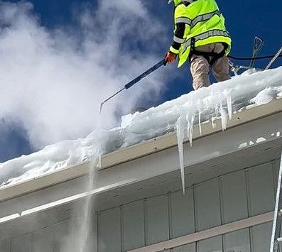 Rooftop ice and snow falls unexpectedly. Revelation Roofing snow removal tech uses an artic steamer machine to carefully melt away thick ice and snow before it slides unexpectedly damaging the roof eave, gutters, heat tape and endangering pedestrians below.