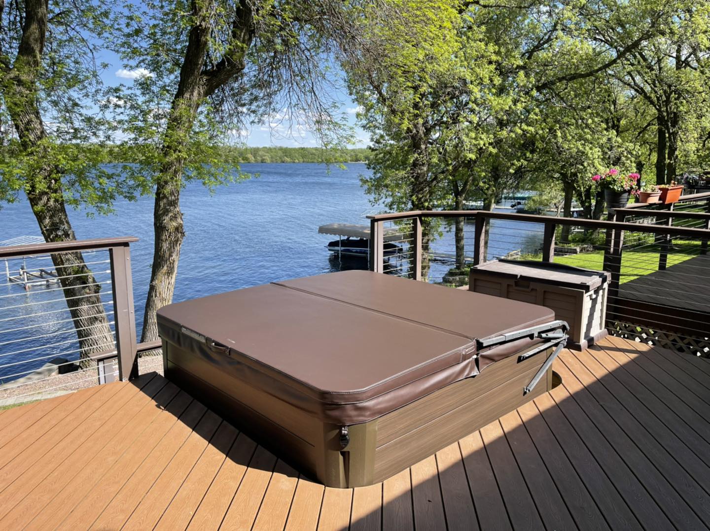 hot tub on deck with lake