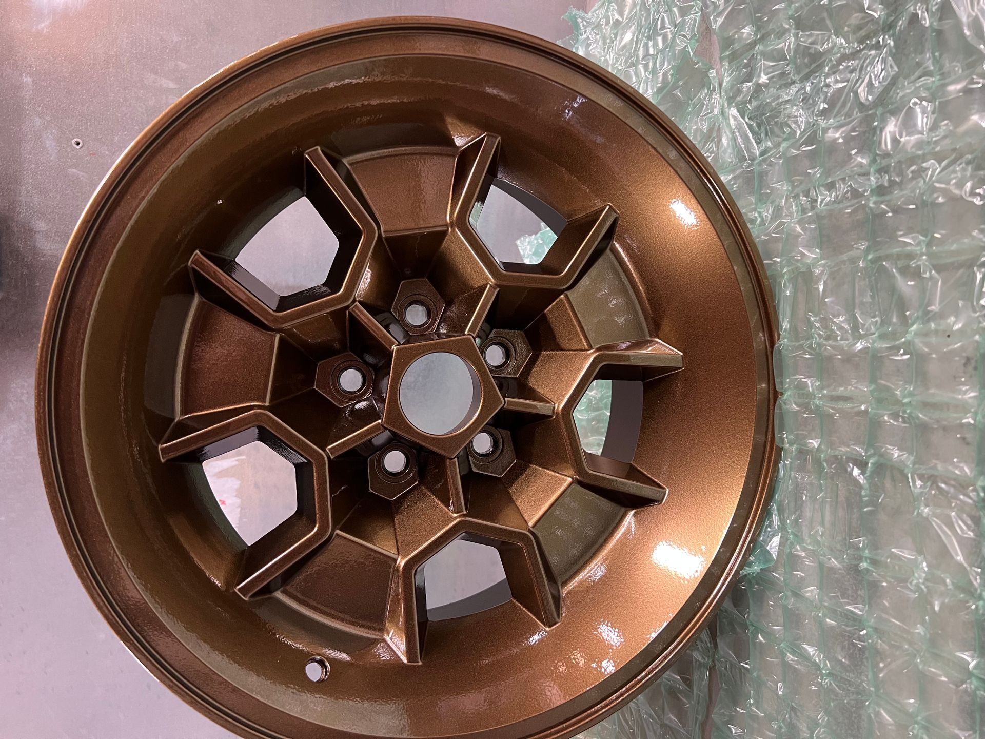 A close up of a wheel on a table. San Diego, CA — Barrio Logan Powder Coating and Sandblasting
