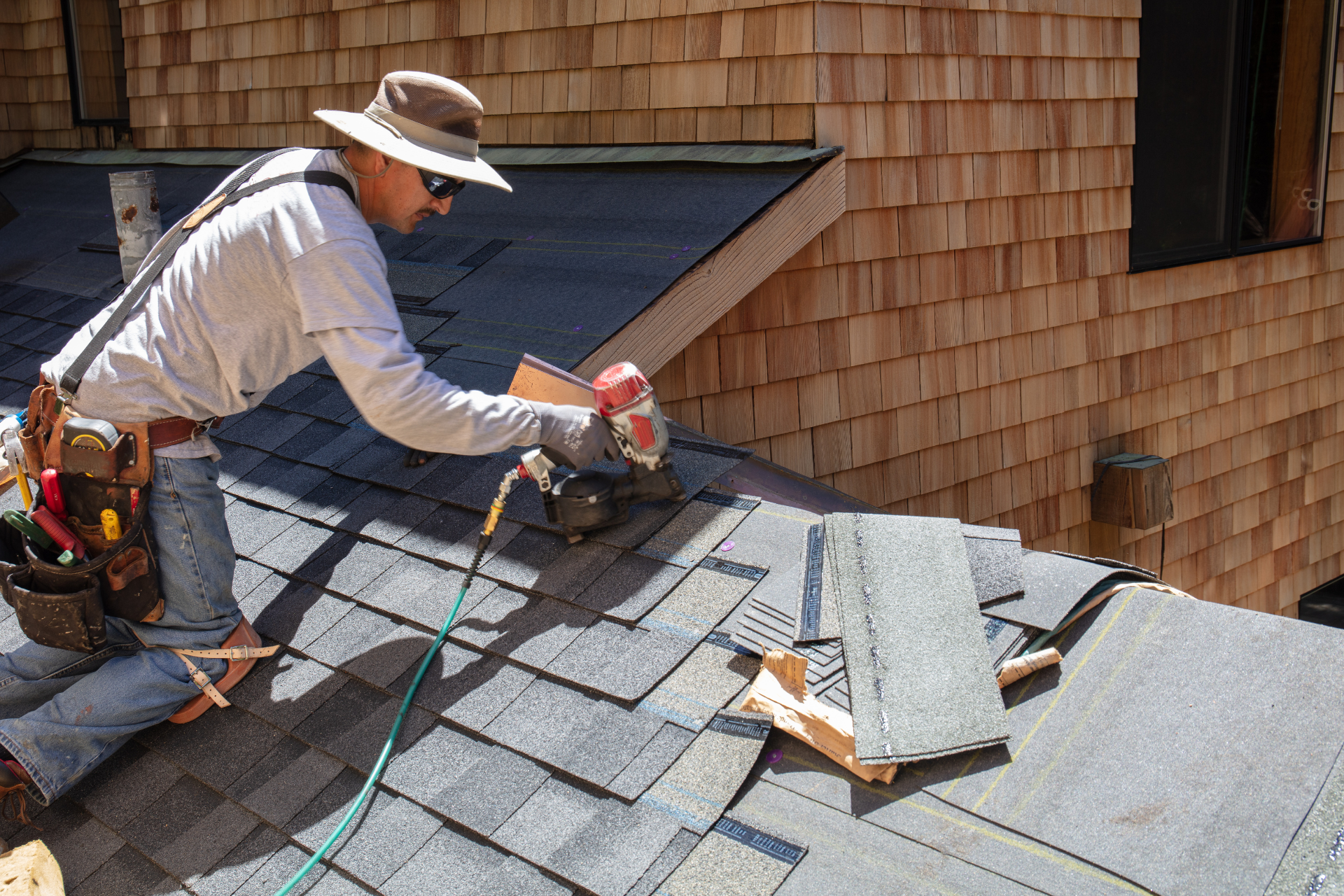 a man is working on the roof of a house.