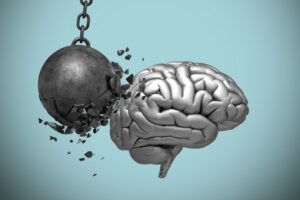 A wrecking ball is hitting a brain on a chain.