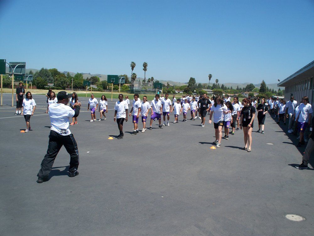 A group of people are standing on a concrete surface