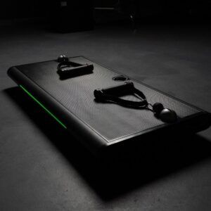 A black table with a green light on it is sitting on a concrete floor.