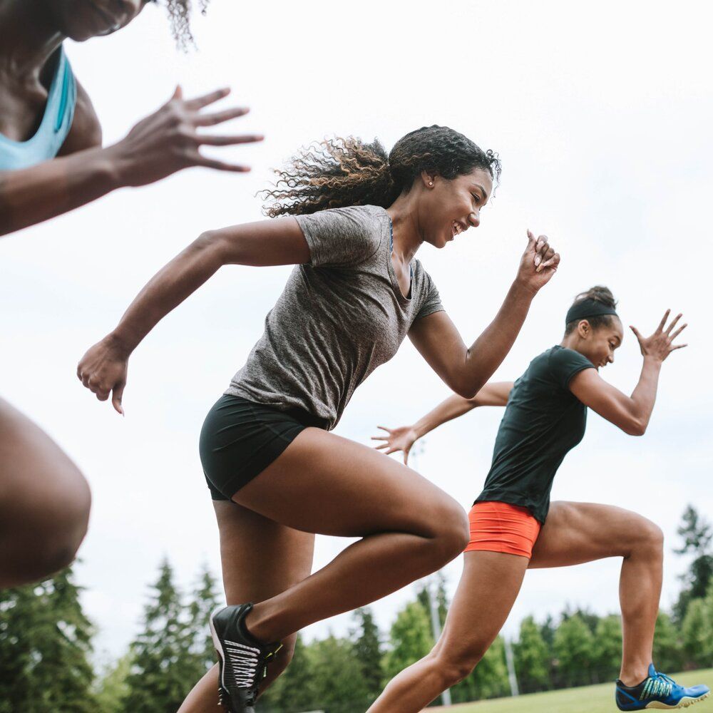 A group of women are running on a track.