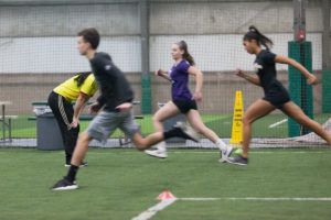 A group of people are running on a field.