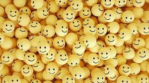 A bunch of smiley faces are sitting on top of each other.