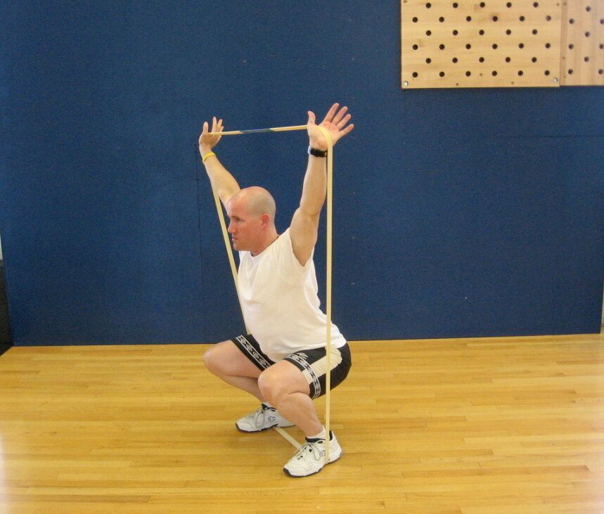 TAKU Doing an Over Head Squat with Woody Band