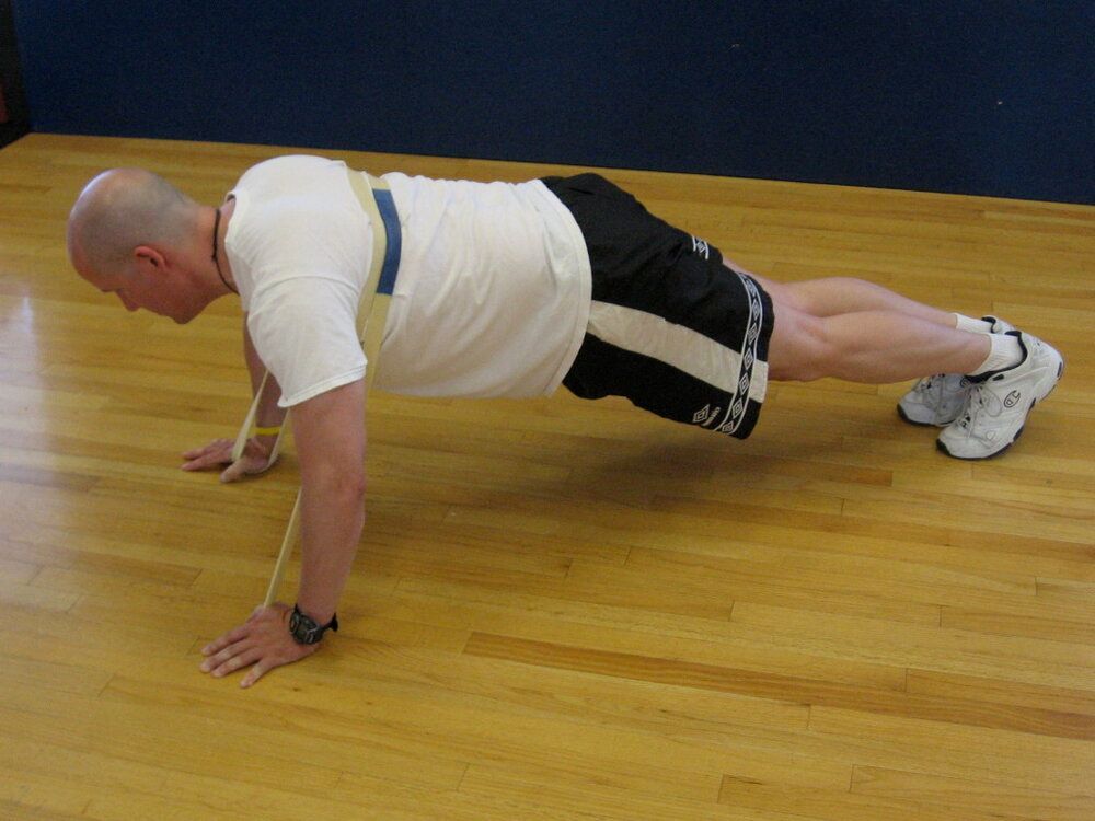 TAKU Doing a Resisted Push-Up with a Woody Band