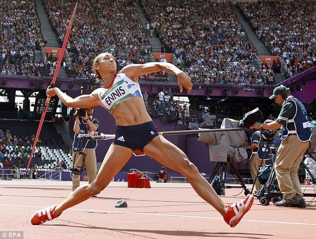 A woman is throwing a javelin in a track and field competition