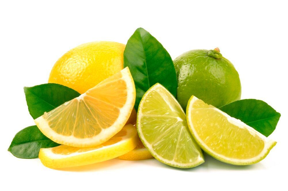 Lemons and limes with leaves on a white background