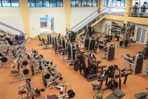 A large gym filled with lots of exercise equipment