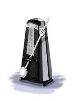 A black and silver metronome with a fork attached to it.