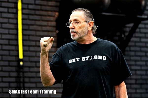 A man wearing a black shirt that says get strong