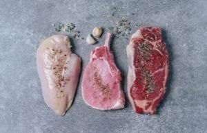 Three different types of meat are sitting on a table.