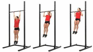 A woman is doing a pull up on a bar.