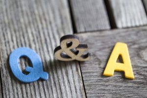 The letters q and a are on a wooden table.