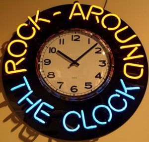 A neon sign that says rock around the clock