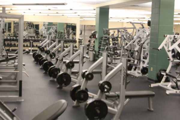 A gym filled with lots of dumbbells and machines