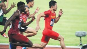 A group of men are running on a track.