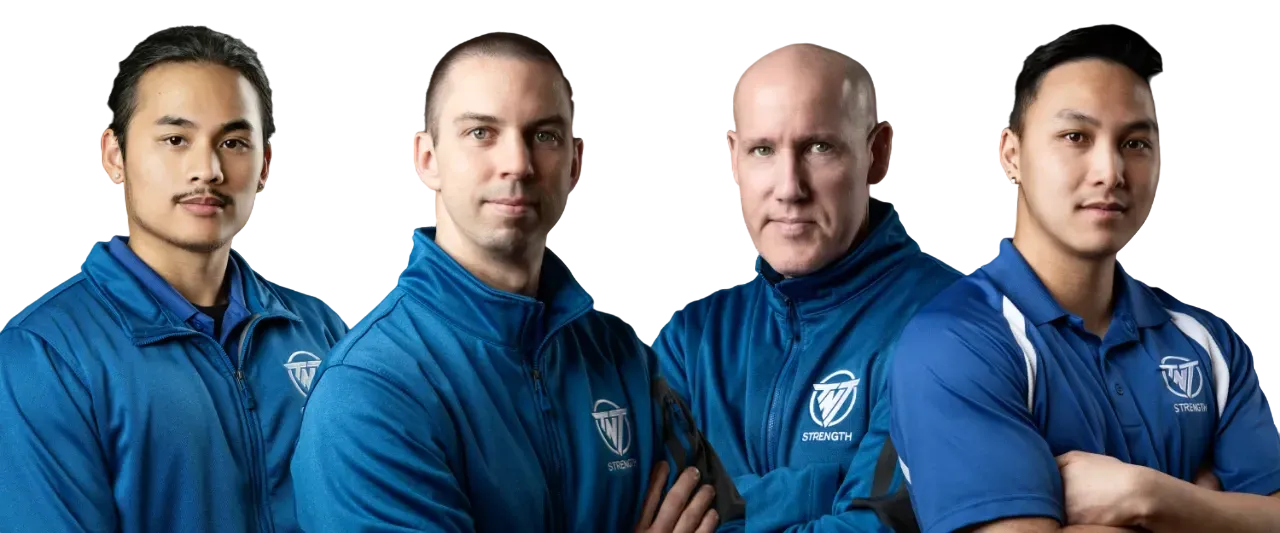 TNT Strength Coaches four in TNT Strength blue jackets standing next to each other.