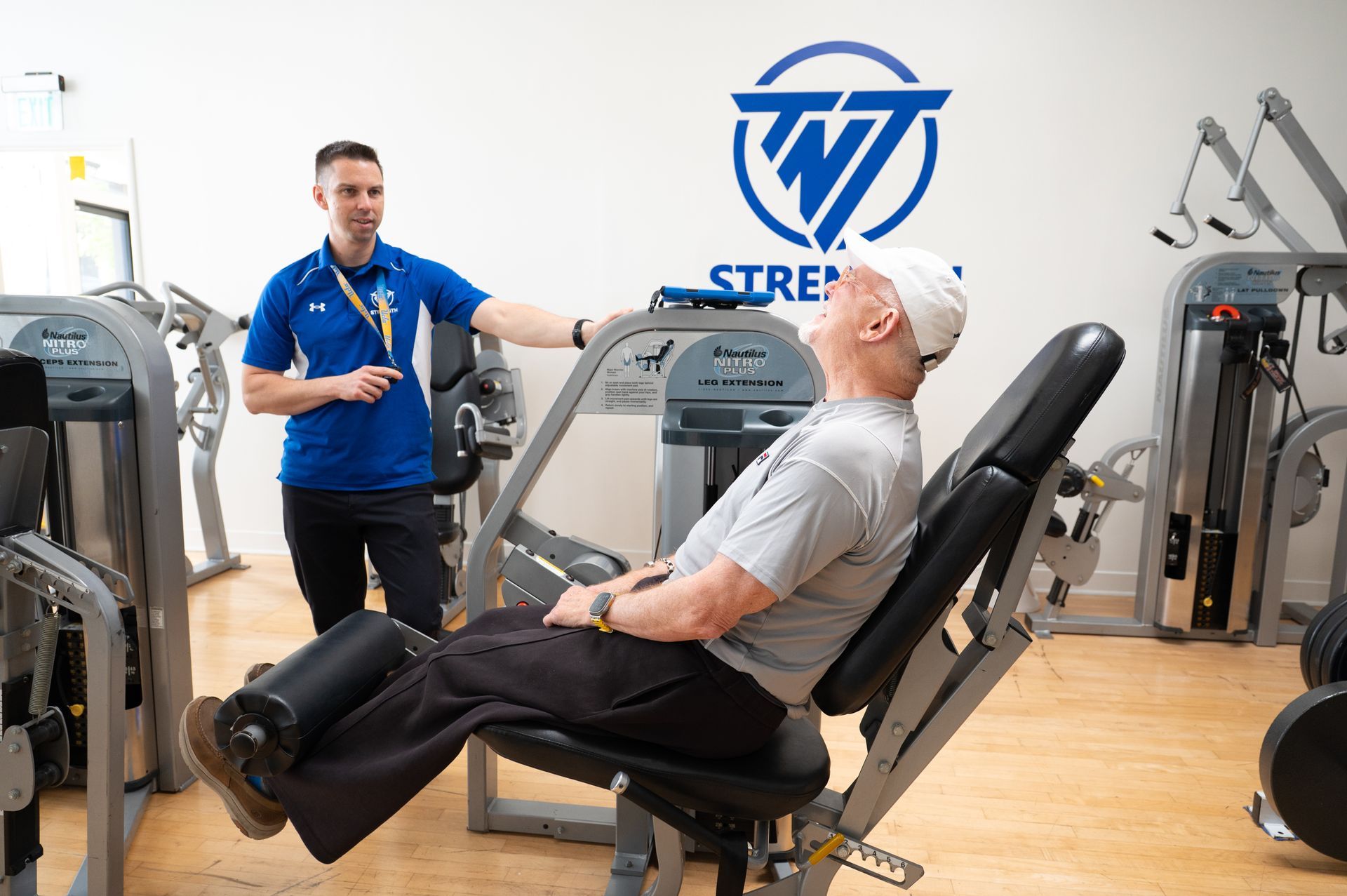 A man is teaching another man how to use a machine