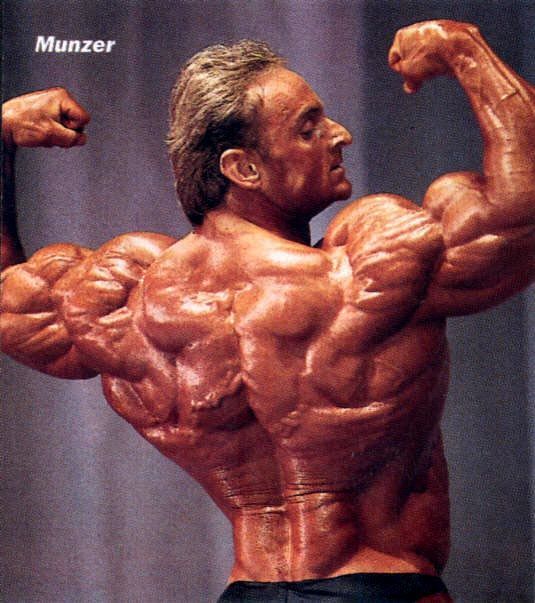 A bodybuilder named munzer is flexing his muscles