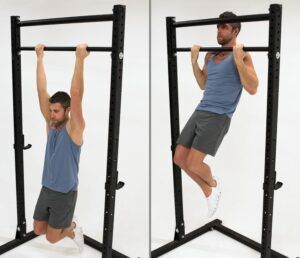 A man is doing a pull up on a bar.