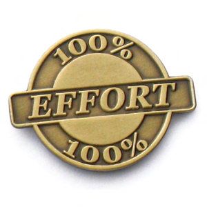 A gold coin that says 100 % effort 100 %