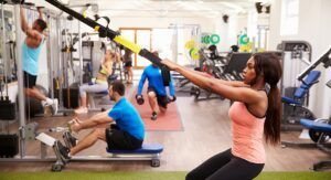 A group of people are doing exercises in a gym.