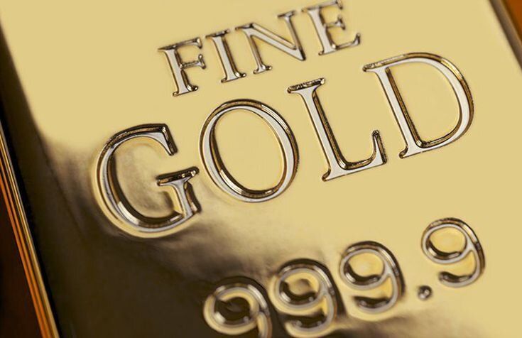 A close up of a gold bar that says fine gold on it