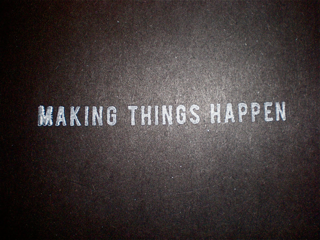 A black background with the words making things happen written on it