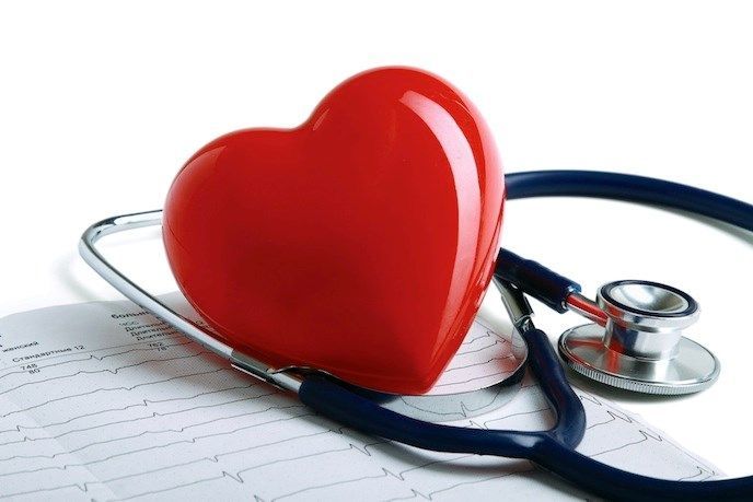 A red heart is sitting on top of a stethoscope