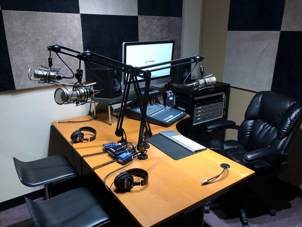 A radio station with a microphone and headphones on the table