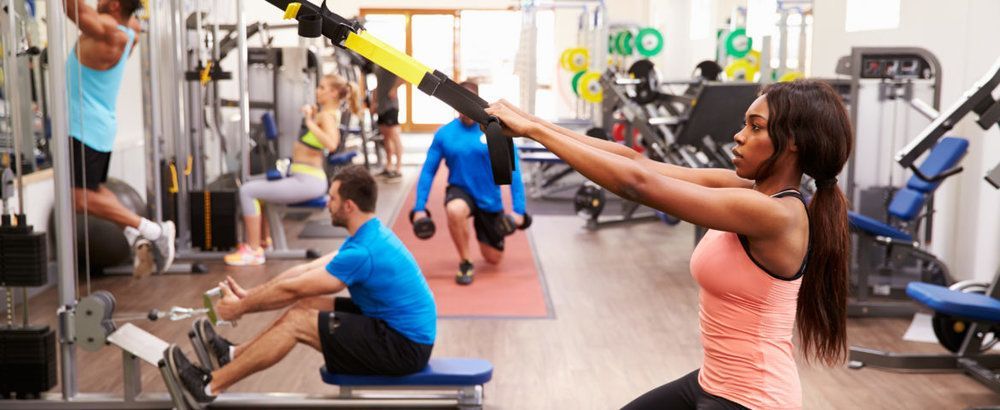 A group of people are working out in a gym.