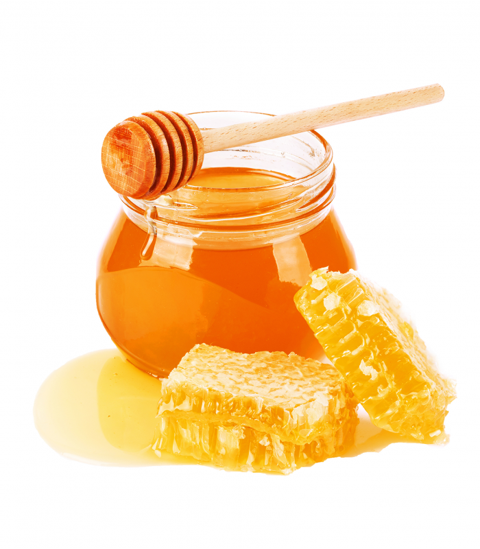 A jar of honey with a honey dipper and honeycomb.