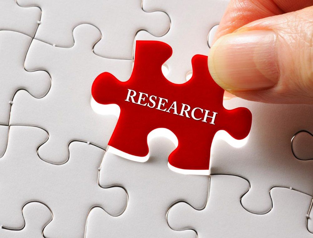 A red puzzle piece with the word research on it