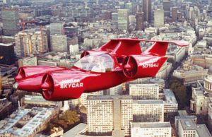 A red skycar is flying over a city