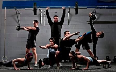 A group of people are doing exercises in a gym