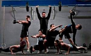 A group of people are doing exercises in a gym.