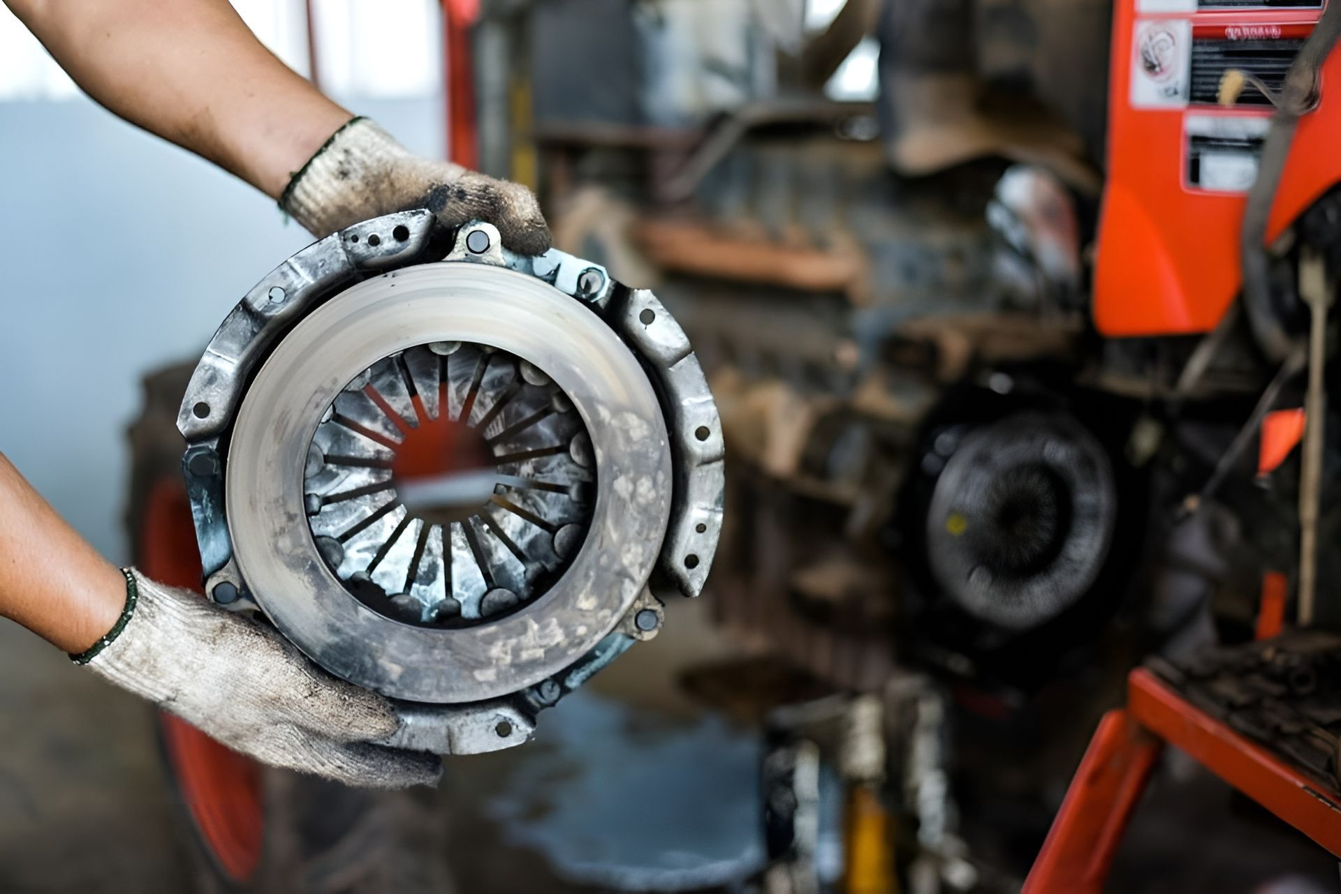 A Man Is Working on A Gearbox in A Garage — Envy Automotive in Gorokan, NSW