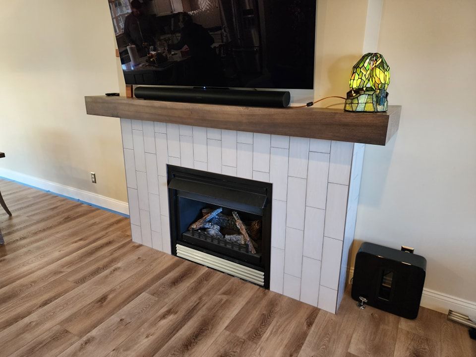 Fireplace with white brick surround, dark wood mantel, TV, and soundbar.