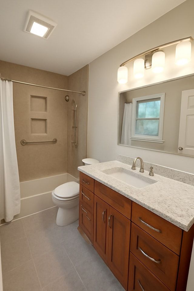 Bathroom with vanity, toilet, and shower/tub. Brown vanity with white countertop. Beige walls and gray floor.