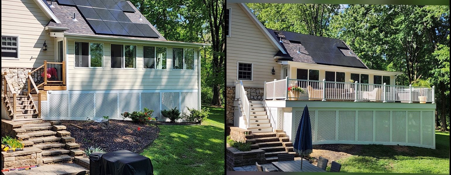 Two white houses with decks and black solar panels, surrounded by trees and a stone staircase.