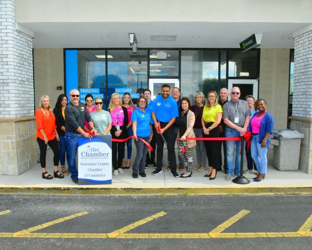 People cutting a ribbon in front of a Spectrum store. The Guardian logo is visible.