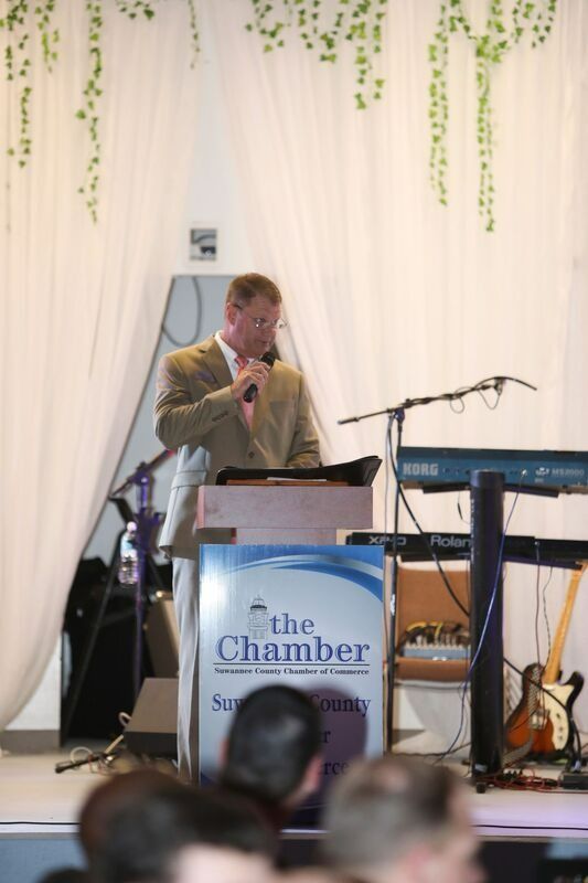 Man speaking at a podium with 