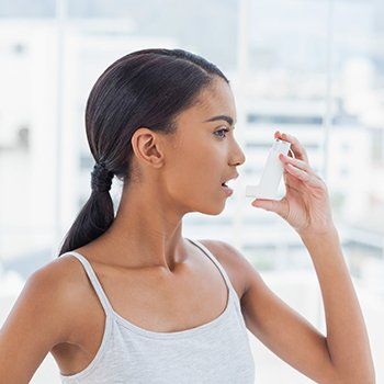 Woman With Inhaler — Bluefield, VA — Allergy & Asthma Center of Bluefield